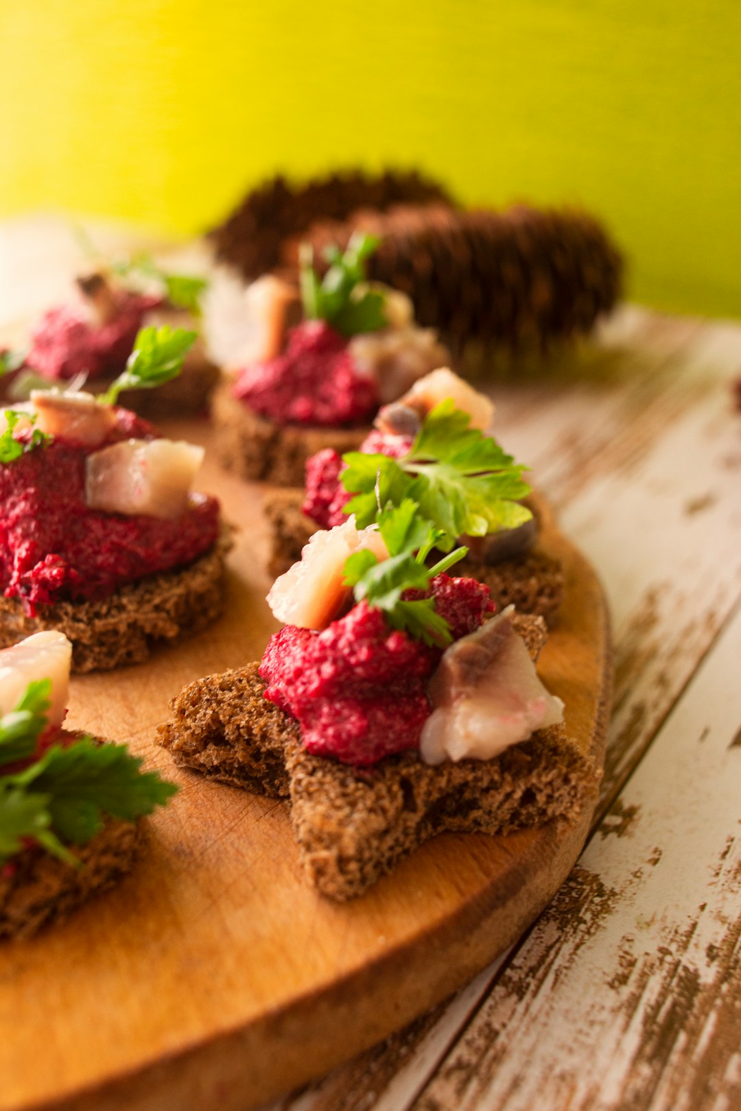 sliced bread with green vegetable on brown wooden chopping board