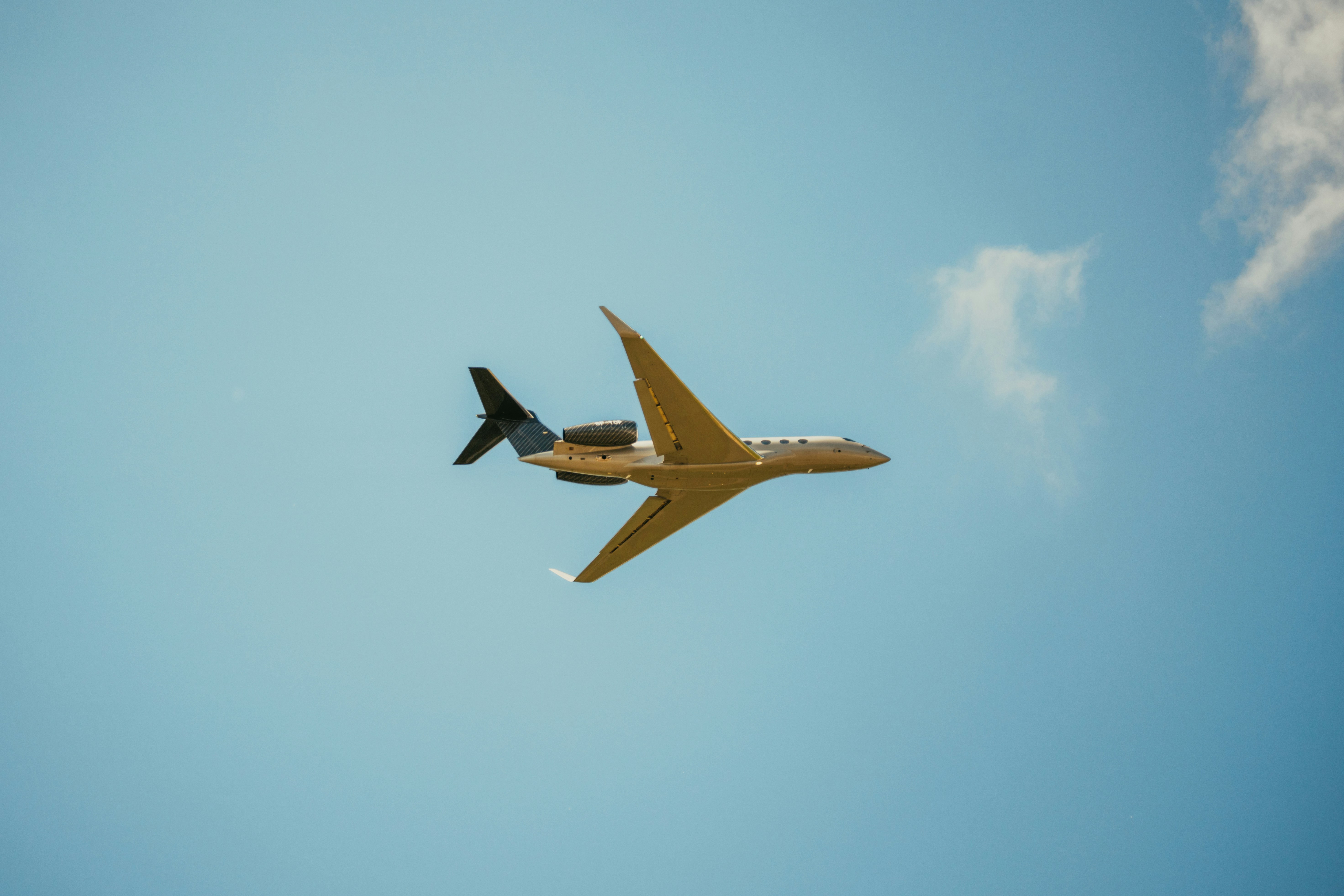 yellow and black plane flying in the sky, 