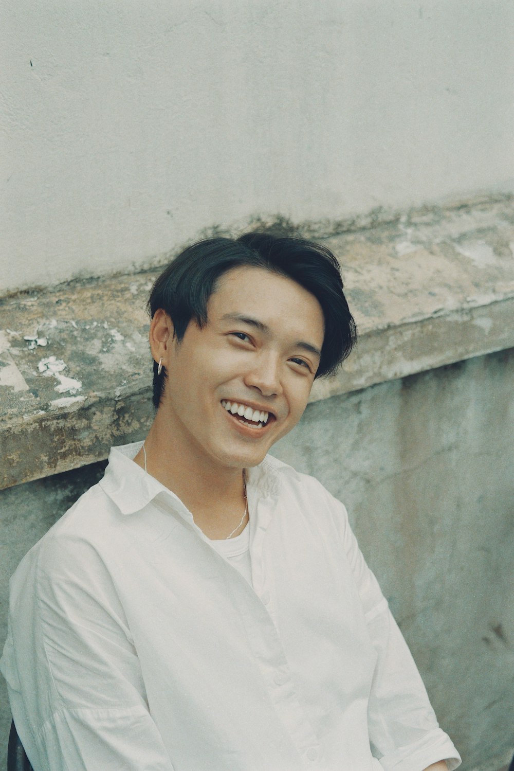 woman in white button up shirt smiling