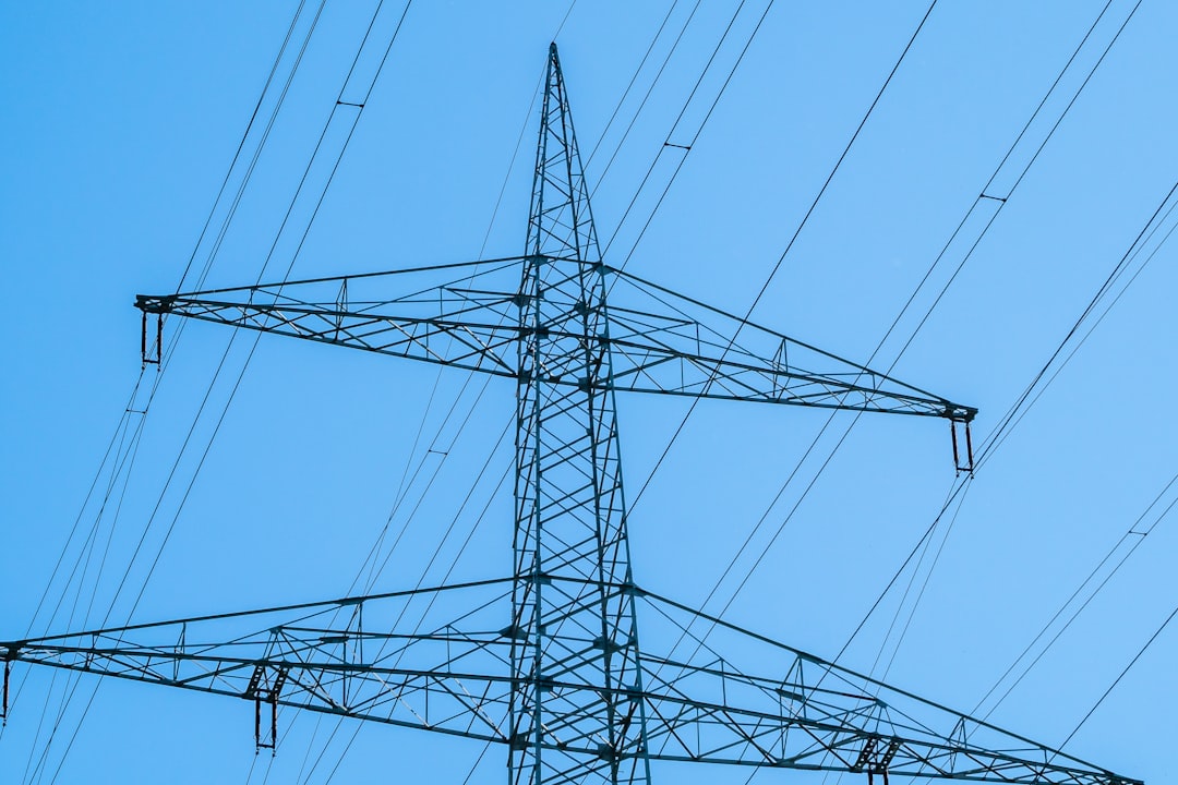 black electric tower under blue sky during daytime