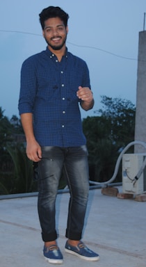 A friendly local roofing specialist standing beside a house, holding a clipboard and smiling.