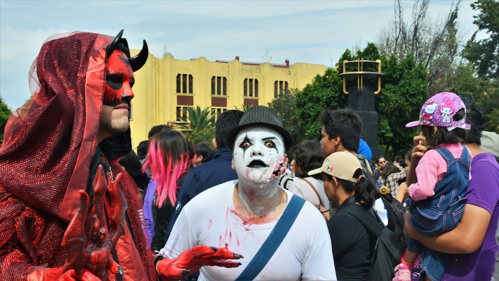 man in white crew neck shirt with red and white face paint