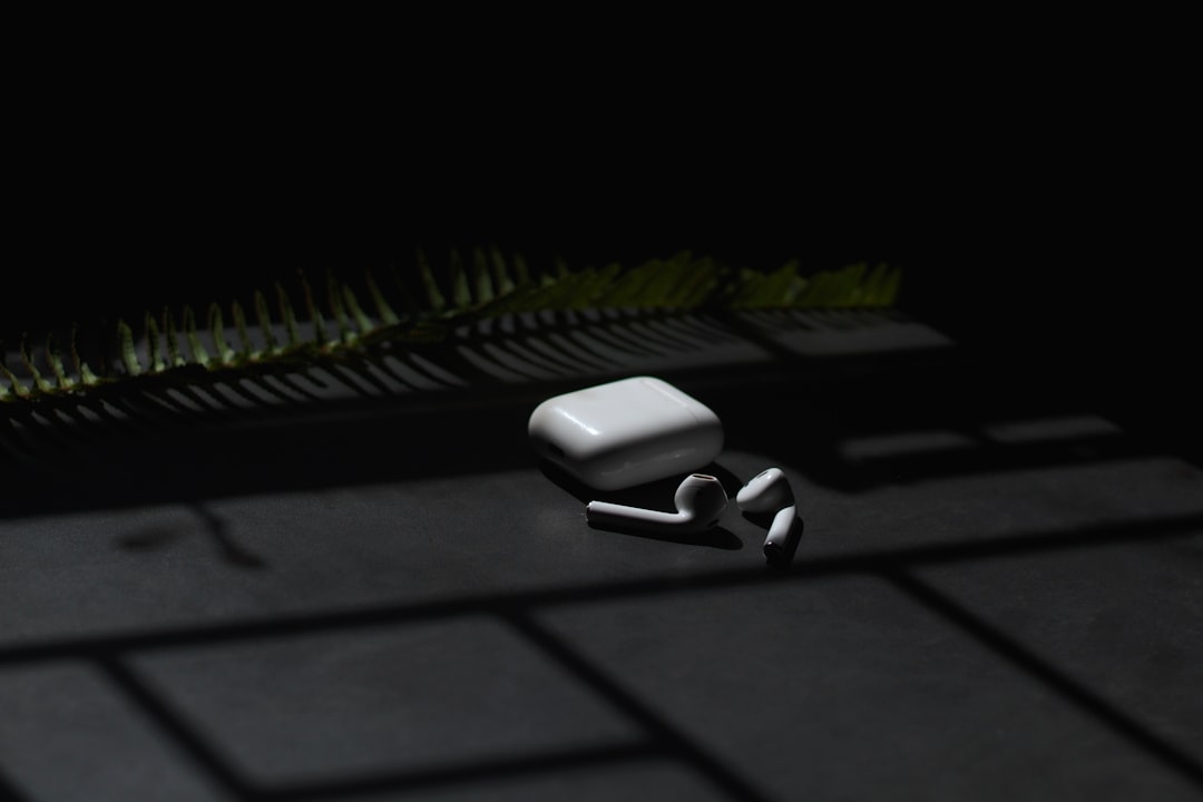 white apple airpods on black surface