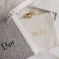 gold and diamond ring on white textile