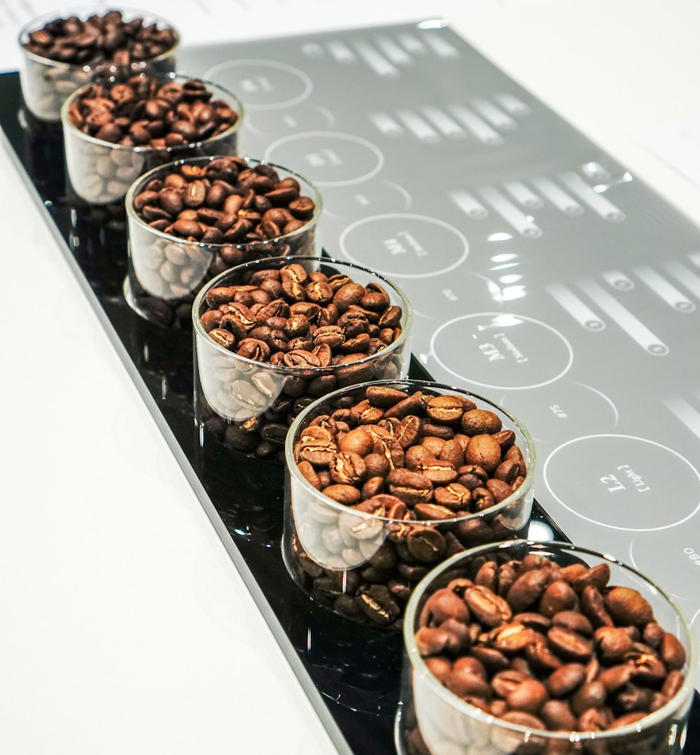 brown and white nuts in stainless steel bowls