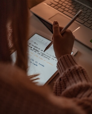 person writing on white paper