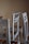 Close-up of hands assembling a sleek wooden chair in a bright room.