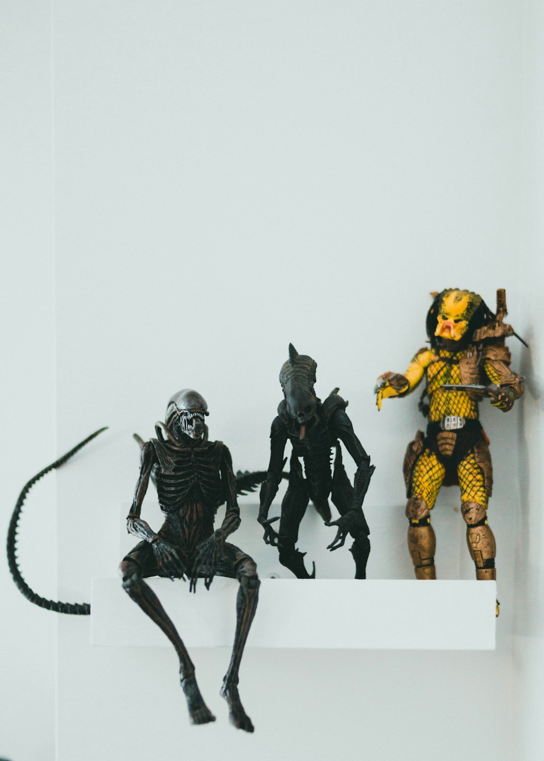 3 men in black and yellow suit action figures