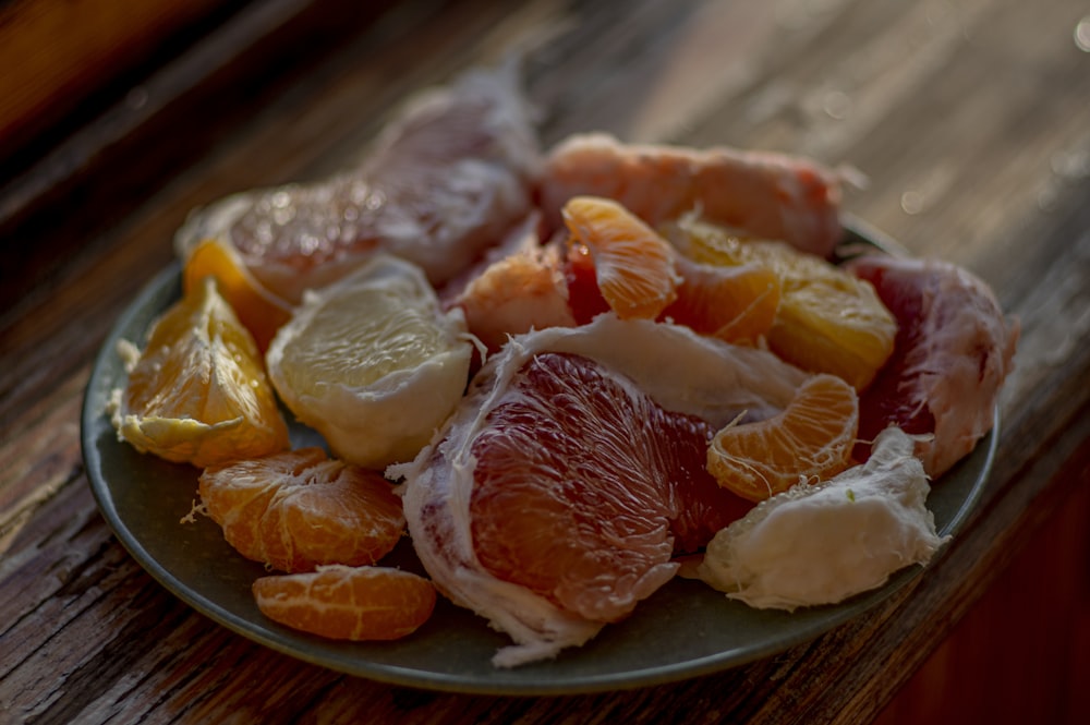 sliced orange fruit on brown wooden round plate