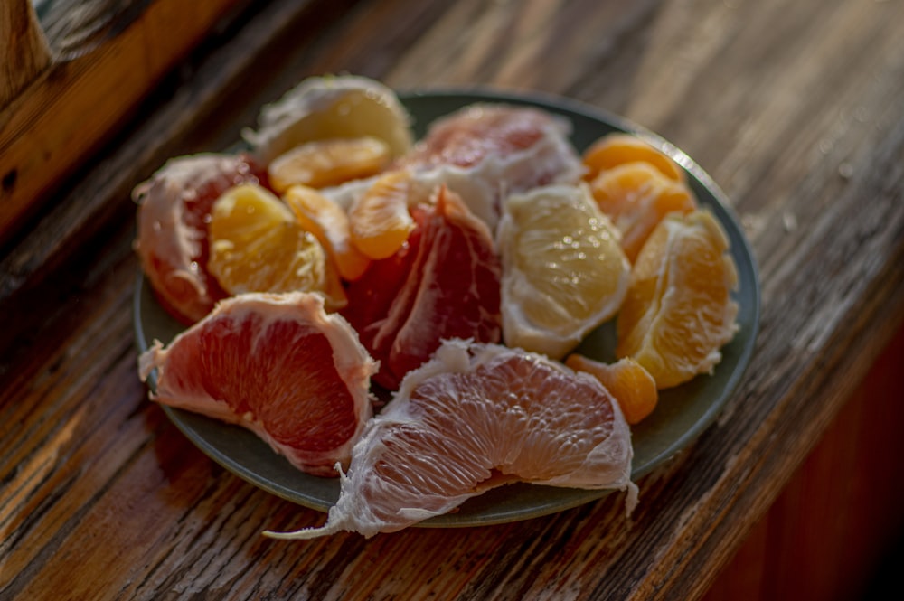 sliced orange fruit on stainless steel plate