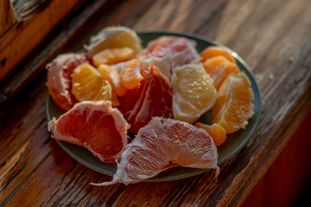 sliced orange fruit on stainless steel plate