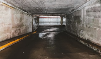 gray concrete tunnel with white wooden window