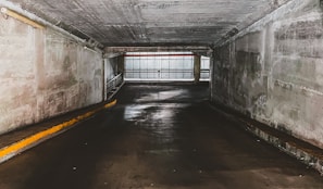 gray concrete tunnel with white wooden window