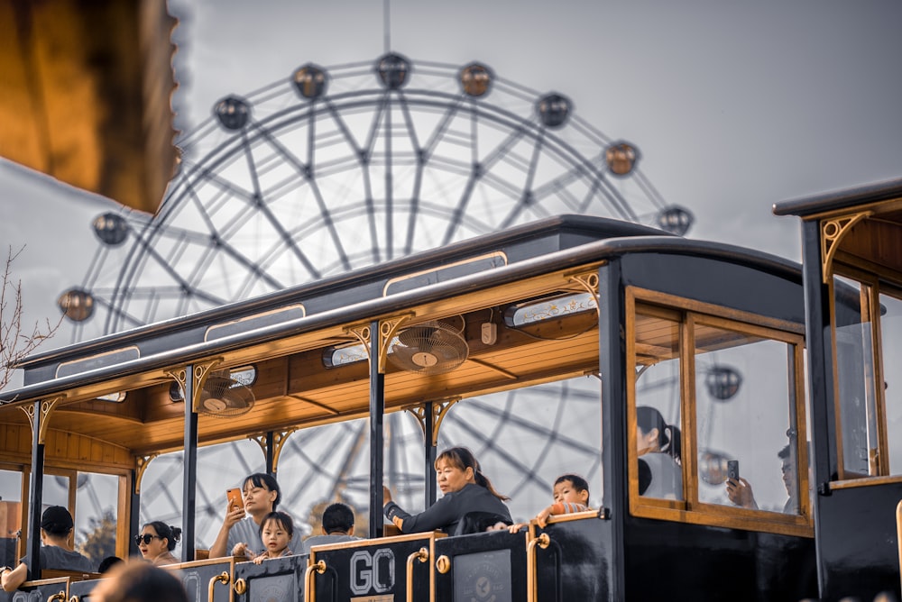 people riding on brown and black tram during daytime