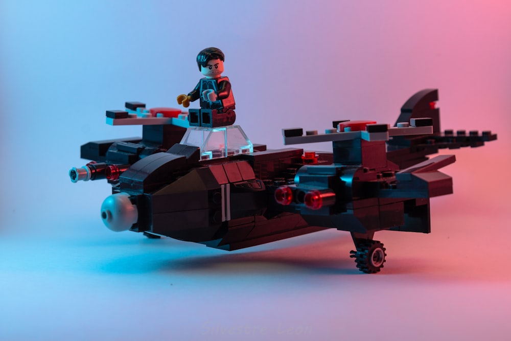 man in black and red suit riding red and black space ship
