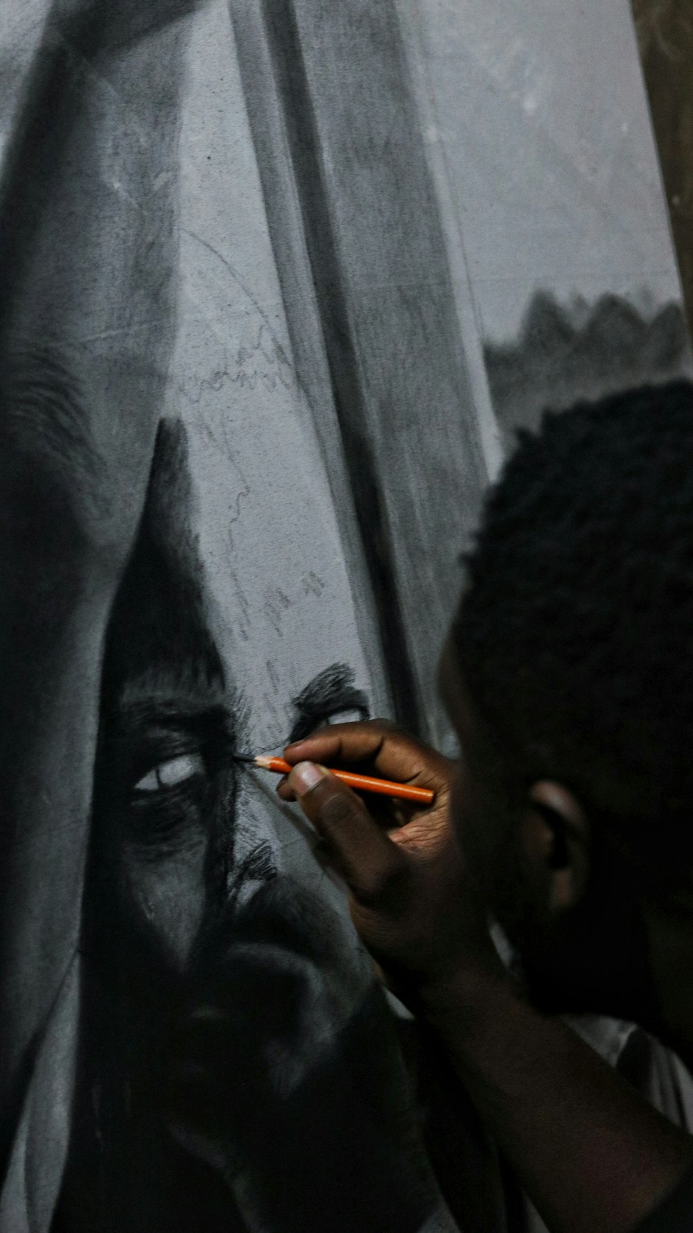 man holding black paint brush