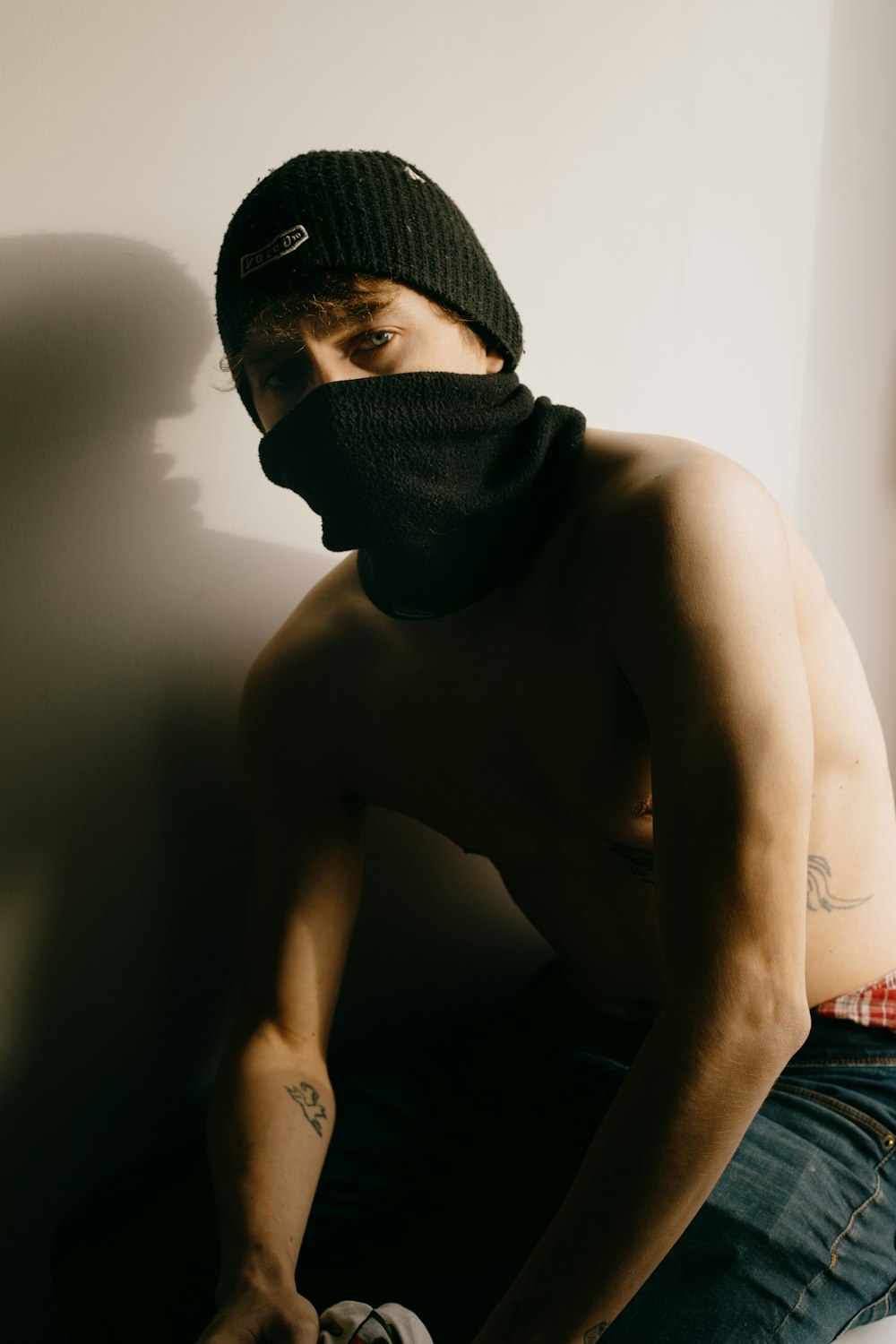 topless man wearing black knit cap