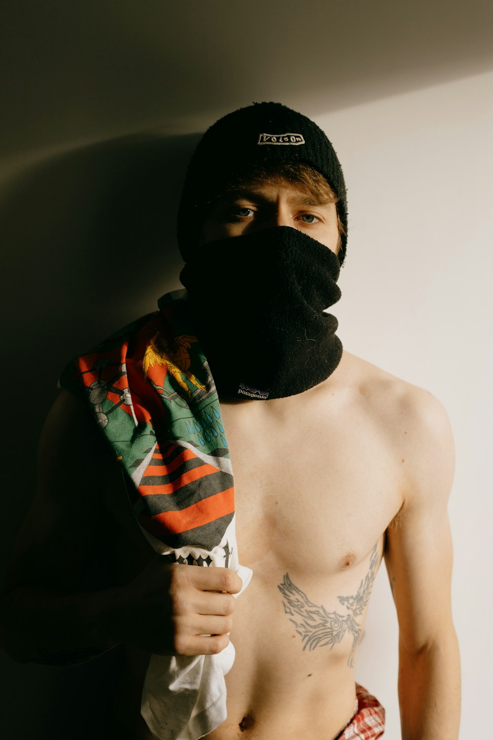 topless man wearing black knit cap