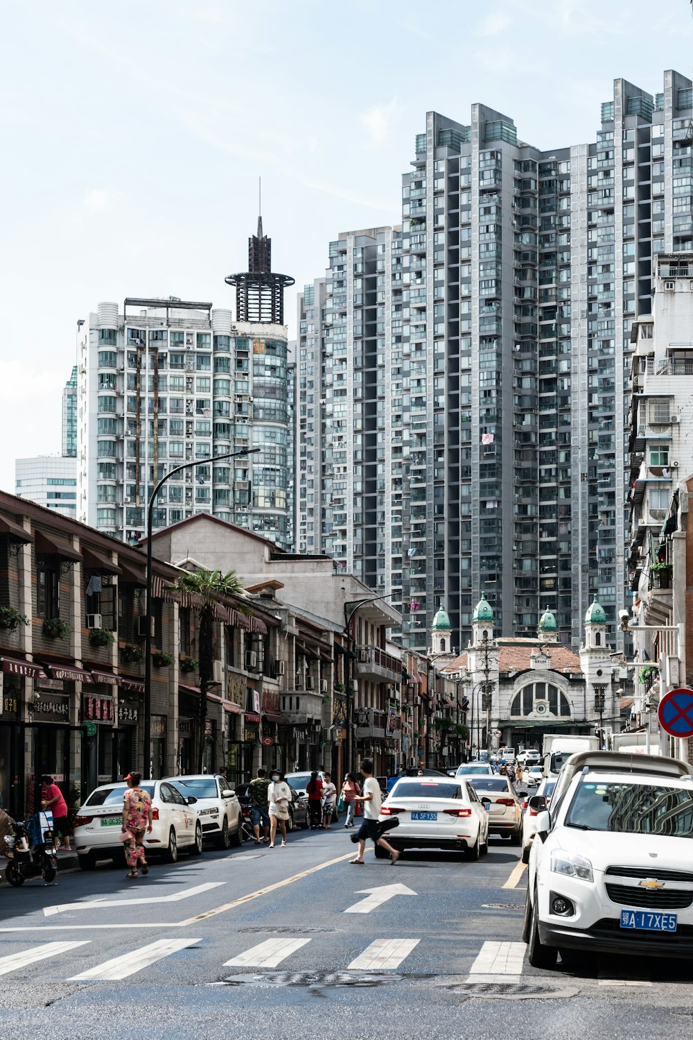 cars on road near high rise buildings during daytime