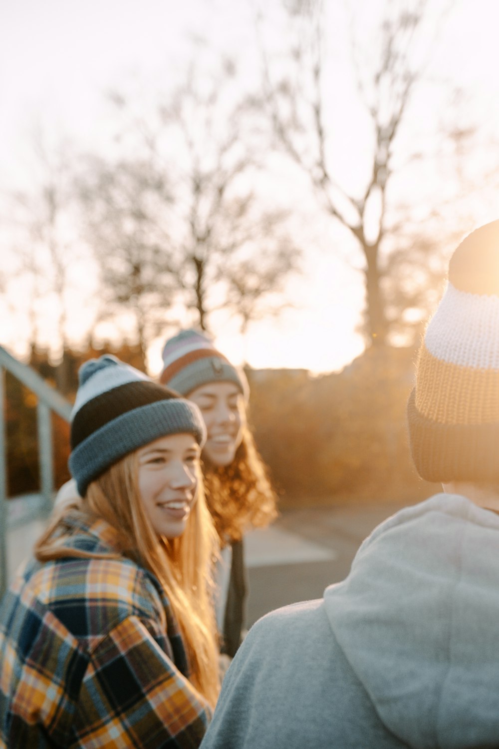 woman in white knit cap and blue white and brown plaid dress shirt