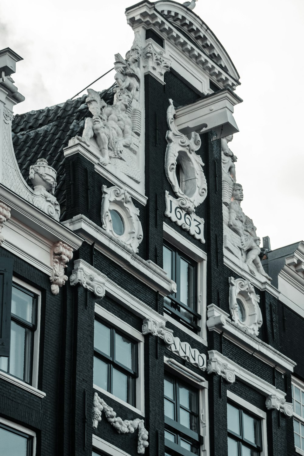 low angle photography of gray concrete building under white clouds during daytime