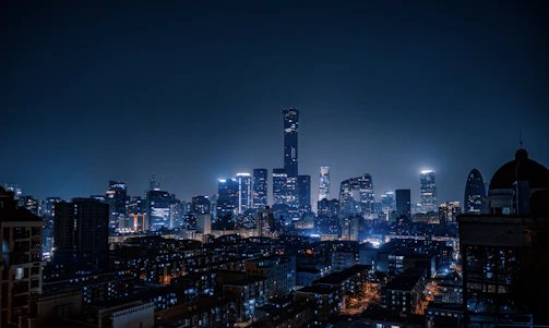 Night cityscape highlighting high-value commercial properties under clear skies.