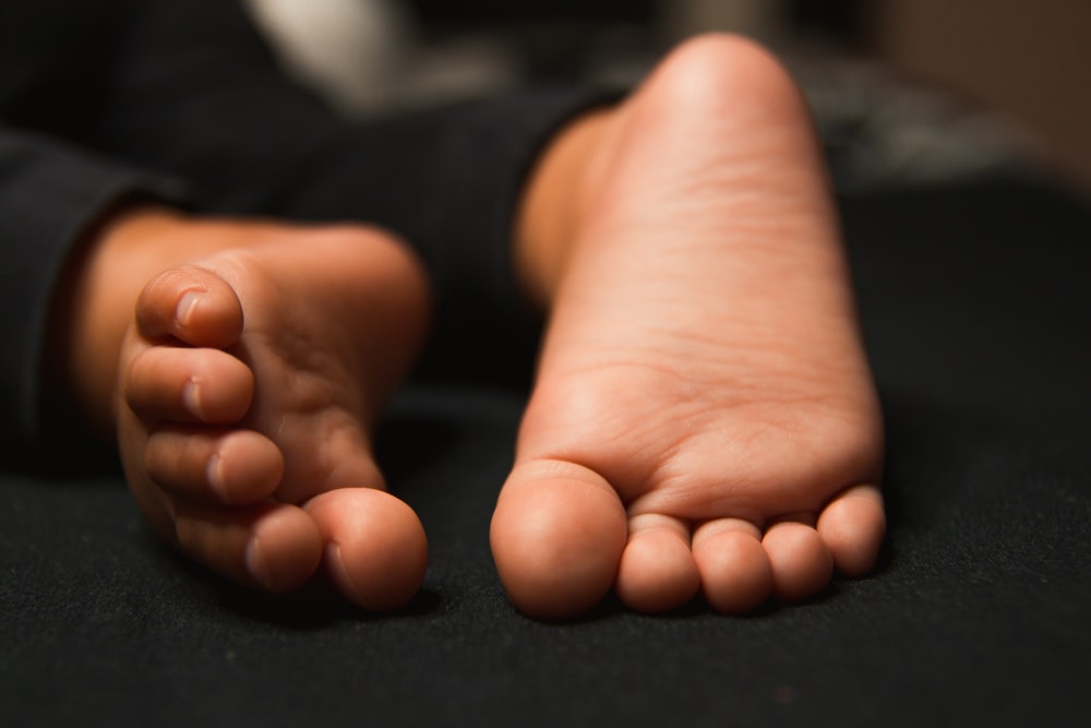 persons feet on black textile