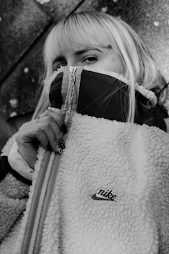 woman in black and white coat holding white leather bag onlyfans