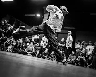 grayscale photo of man in white hoodie and black pants