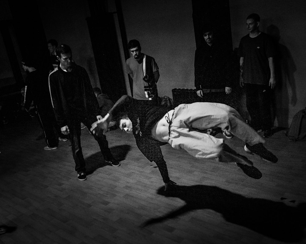 man in black and white shirt lying on floor