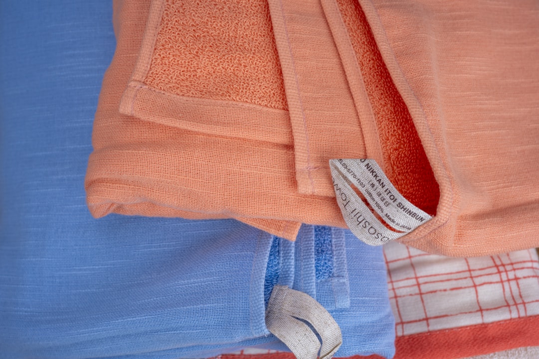 orange and white textile on blue textile
