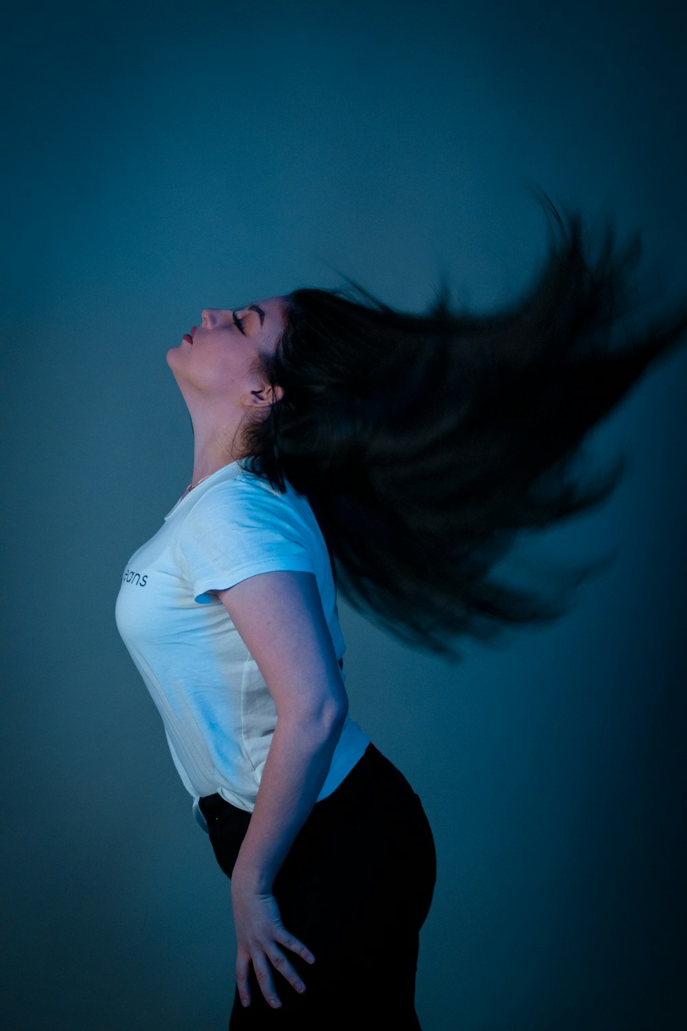 woman in white t-shirt and black pants