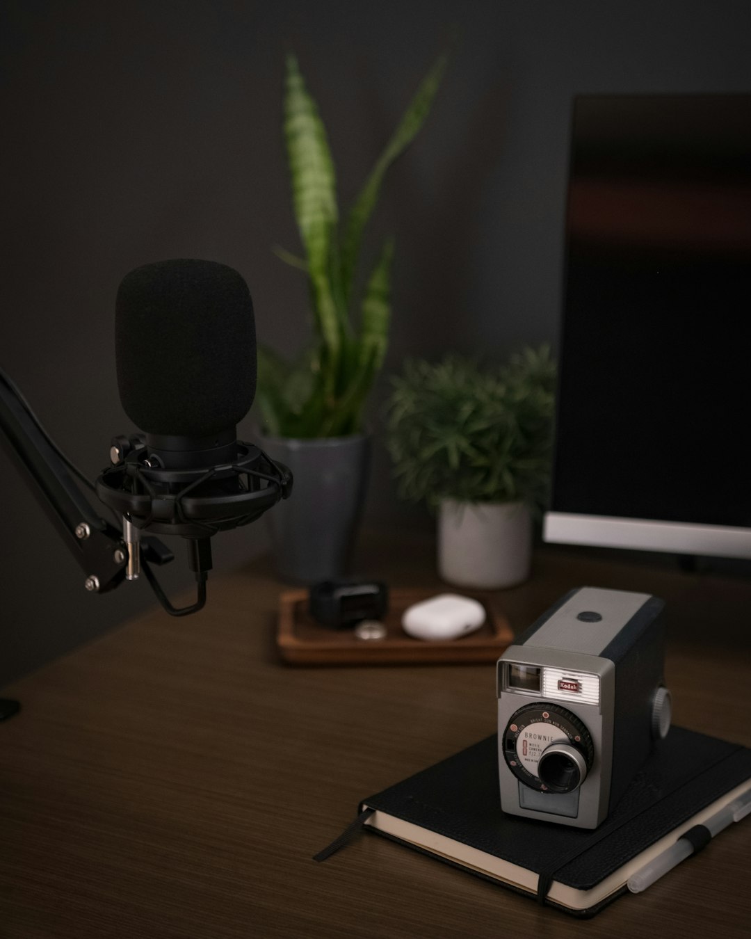 black and silver camera on brown wooden table