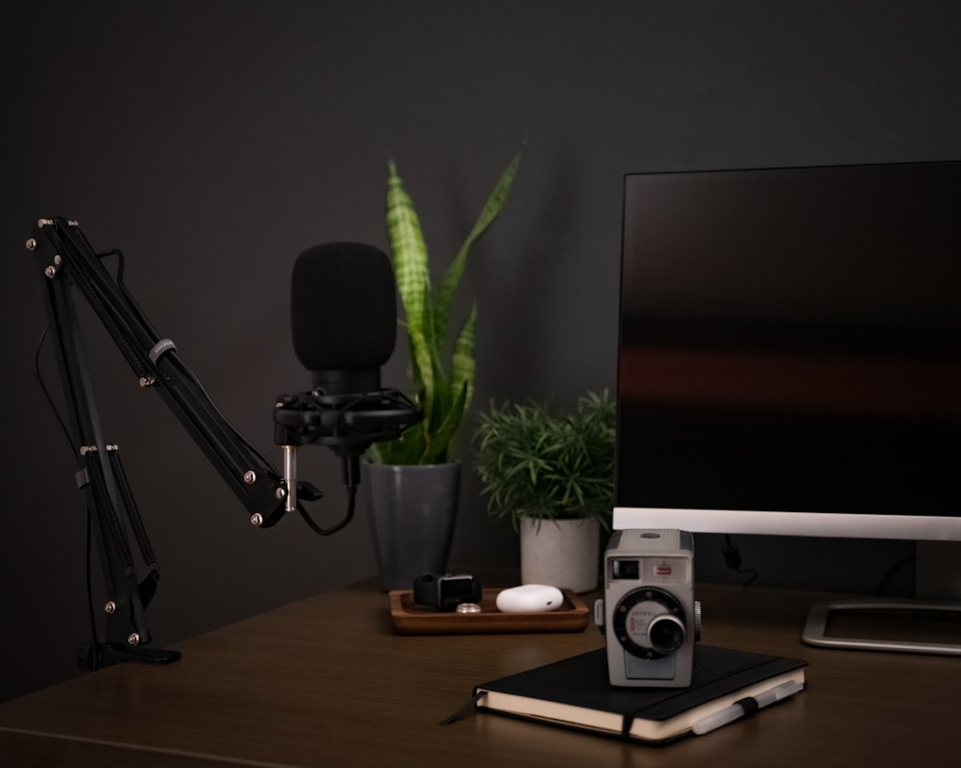 black and silver microphone on brown wooden table