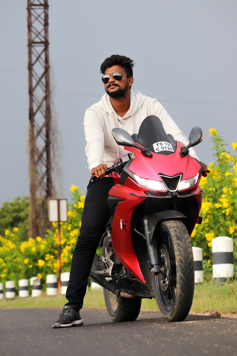 man in white dress shirt riding red and black motorcycle