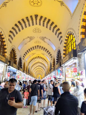 A bustling exhibition hall filled with colorful stalls and displays.