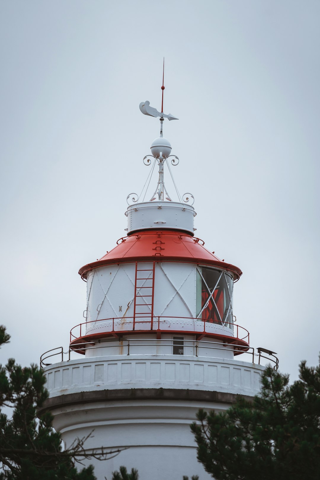 red and white lighthouse under white sky