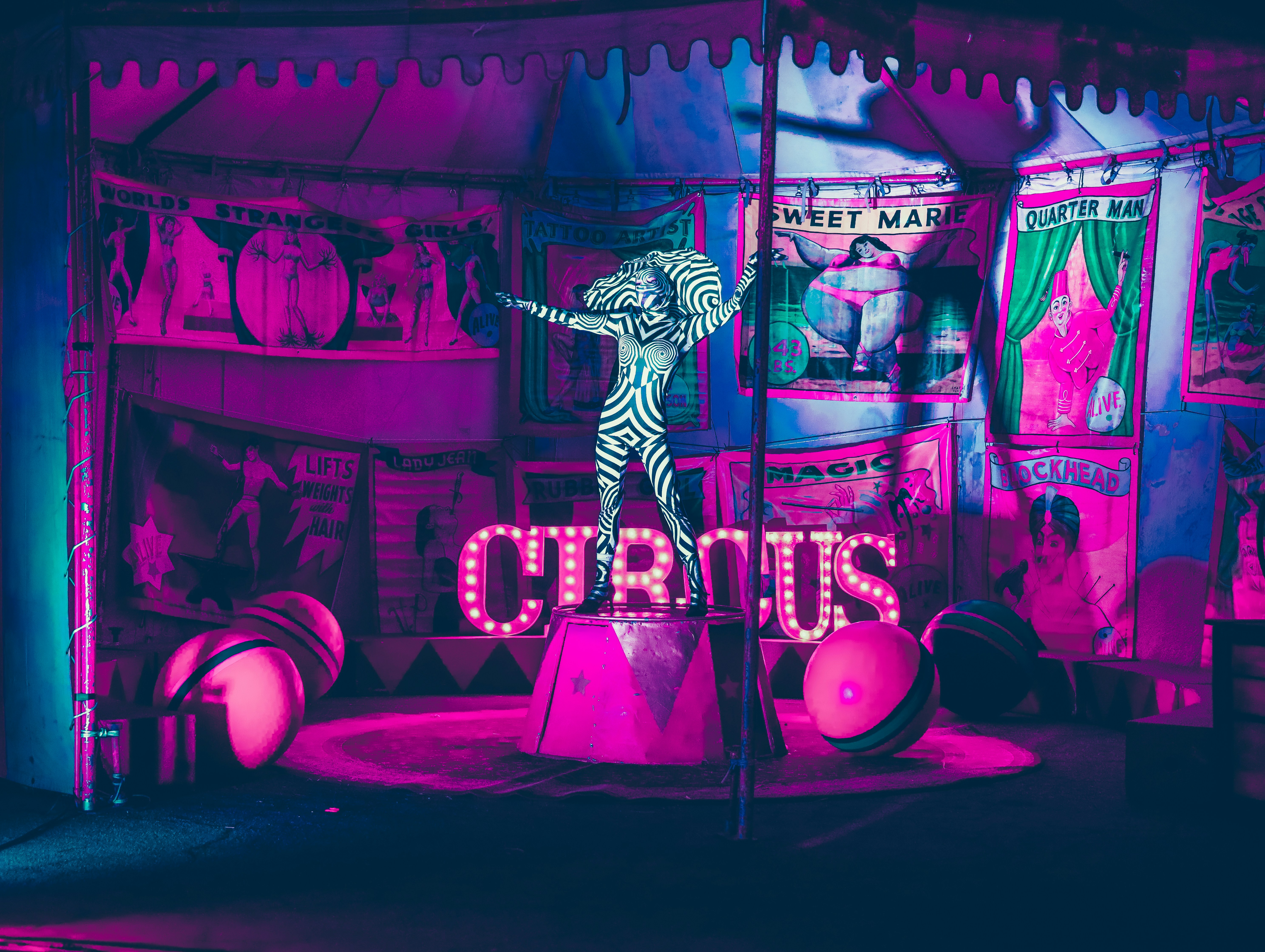 man in black and white shirt standing on stage