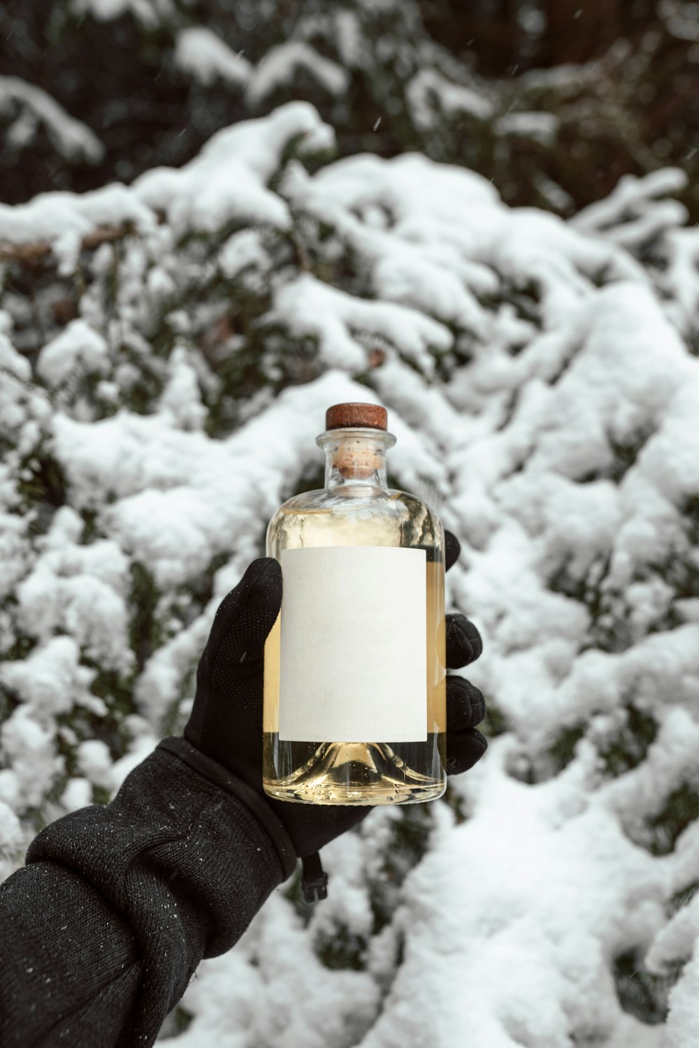clear glass bottle with white snow