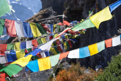 Colorful prayer flags fluttering against the backdrop of Kinnaur’s rugged cliffs.