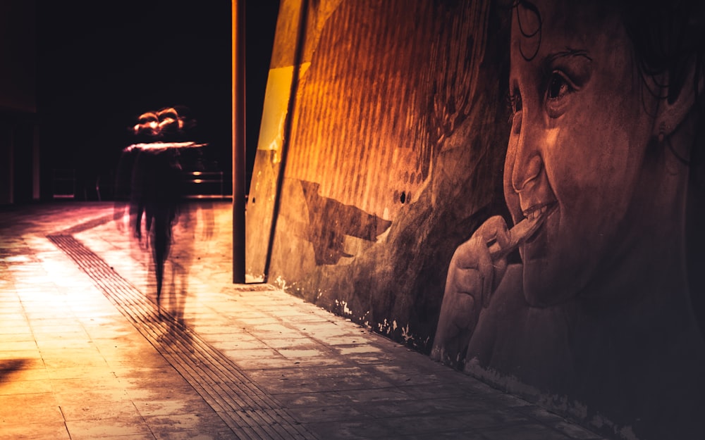 people walking on sidewalk during night time