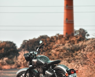 black motorcycle parked on brown field during daytime