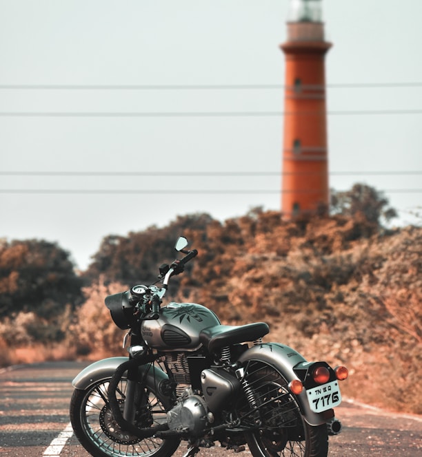 black motorcycle parked on brown field during daytime