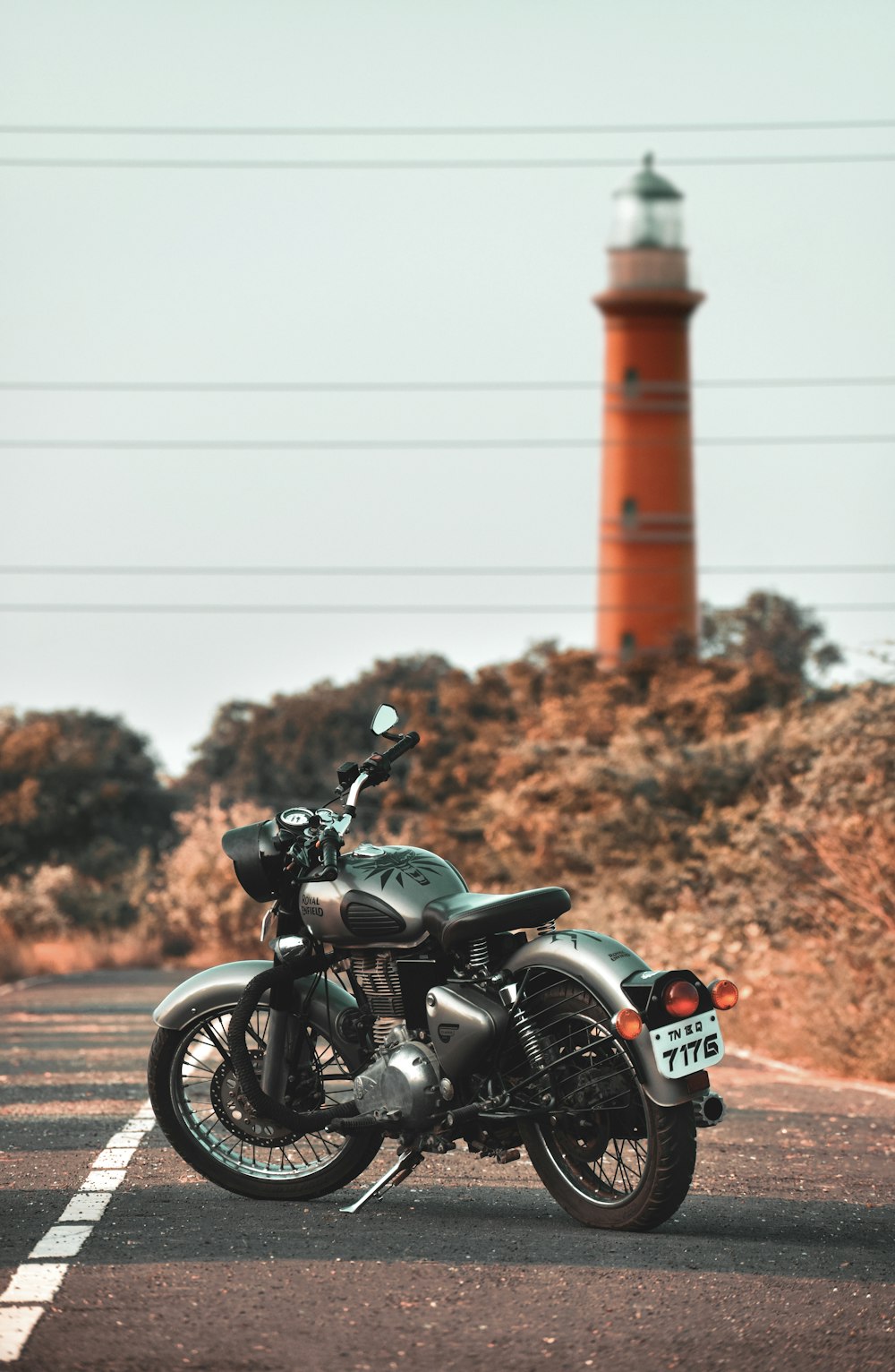 black motorcycle parked on brown field during daytime