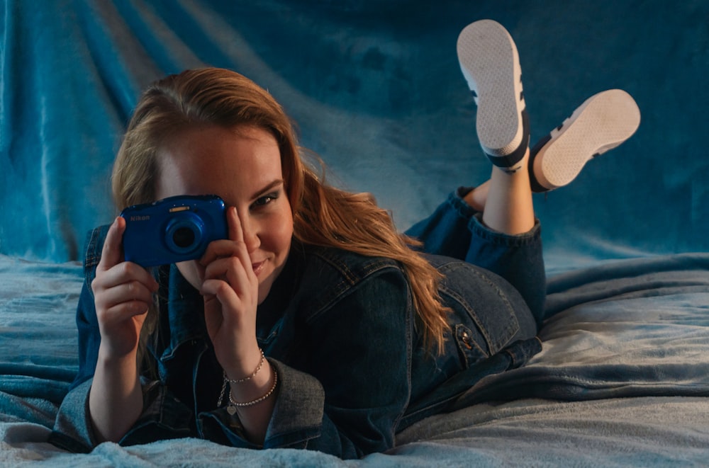 woman in black jacket holding black camera