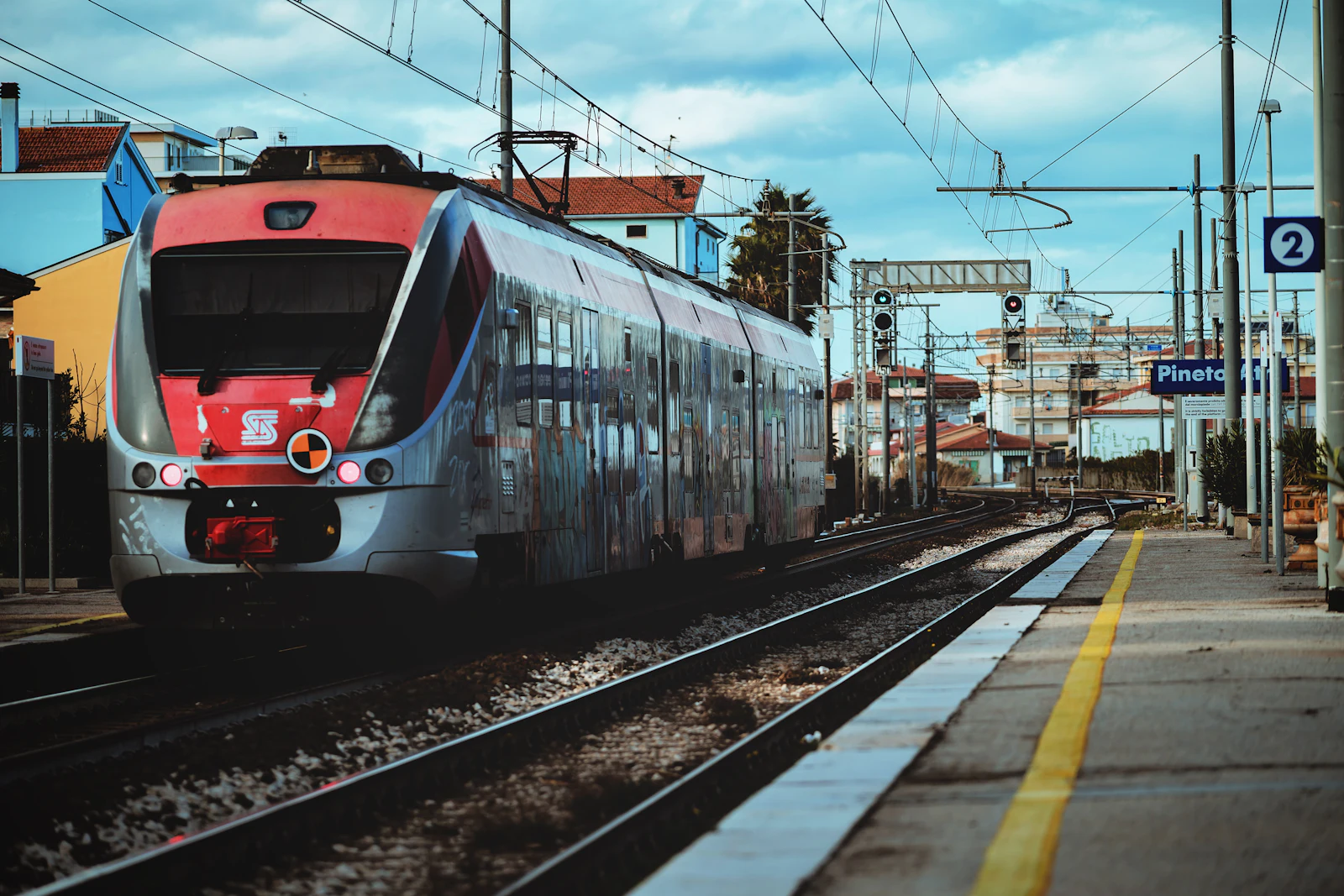Red and white Italian regional train on the tracks