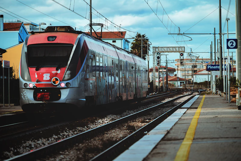 Red and white Italian regional train on the tracks