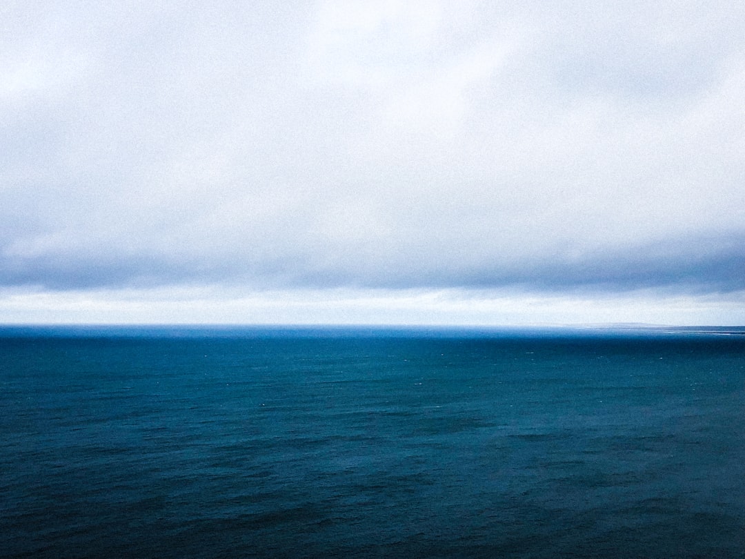 blue sea under white clouds during daytime