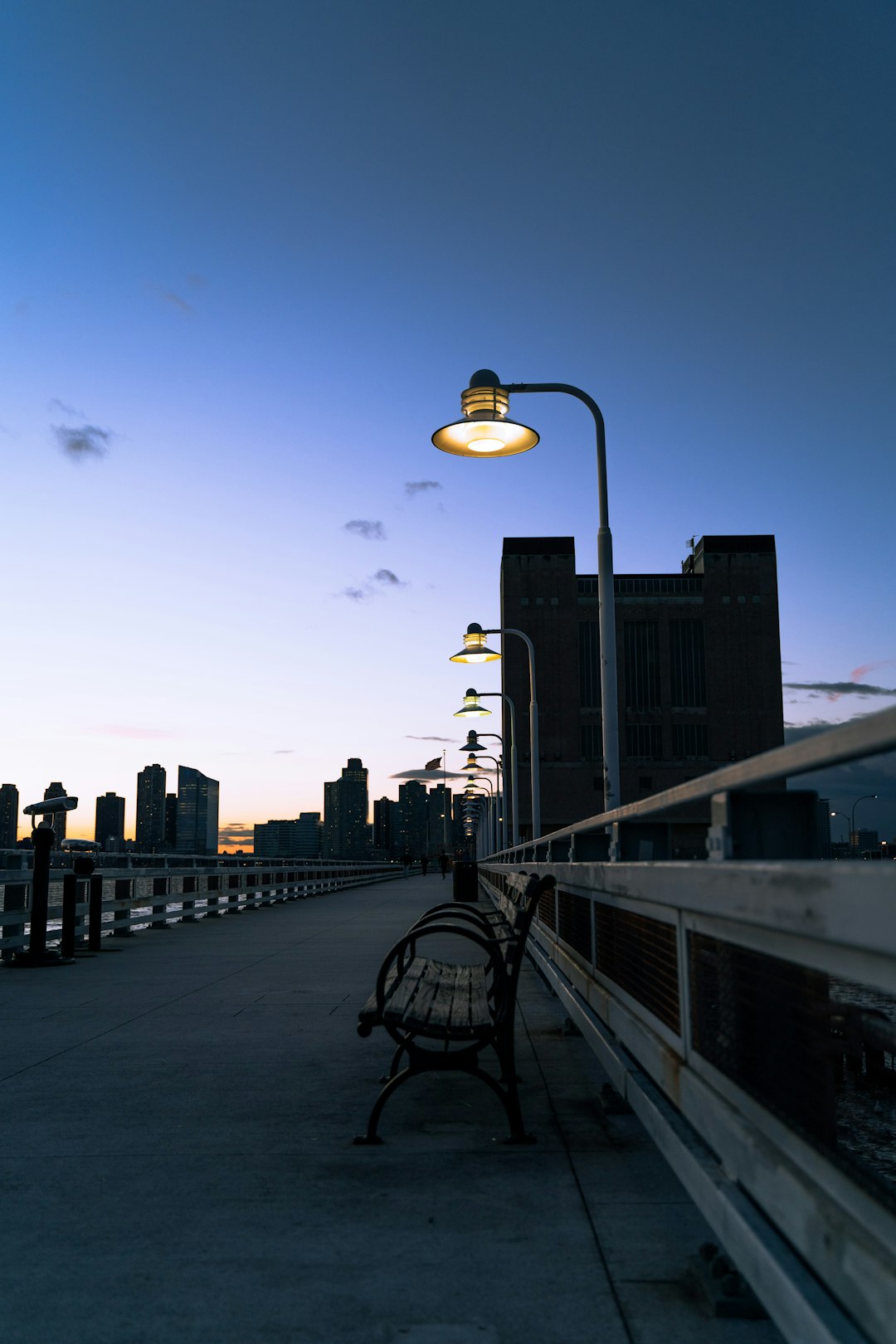 black street lamp near city buildings during night time