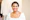 woman in white scoop neck shirt smiling